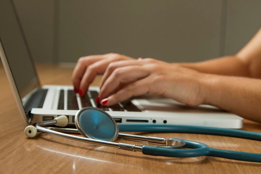 Laptop and stethoscope on a desk for a medical device project
