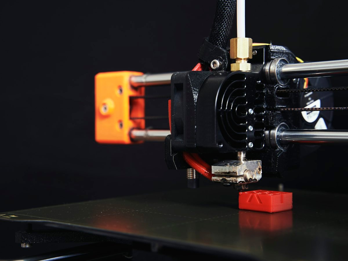 SLA resin 3D printer lifting a translucent blue part from the vat